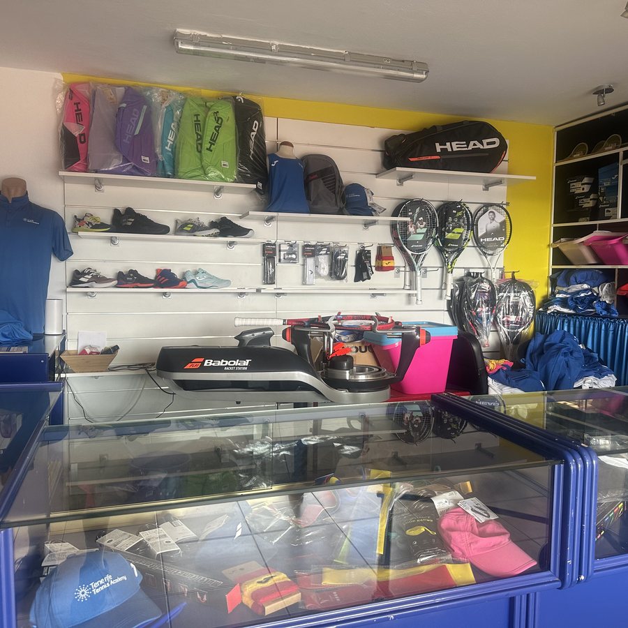 The pro shop at Chayofa, with rackets, shoes and a stringing machine
